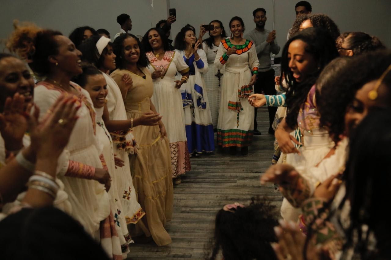 Women in traditional dress celebrating together